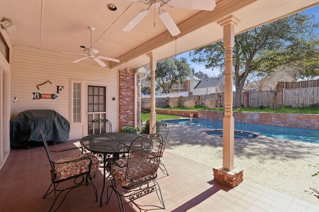 view of patio / terrace with a ceiling fan, a fenced in pool, a fenced backyard, grilling area, and outdoor dining space