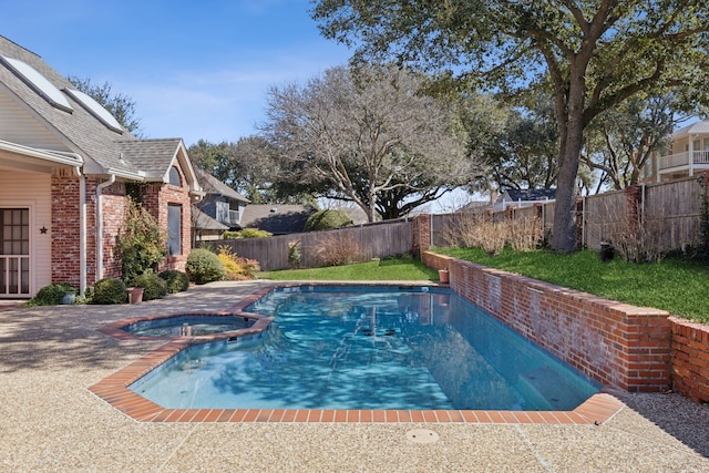 view of pool with a fenced backyard and a pool with connected hot tub