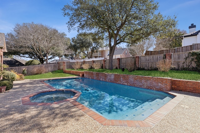 view of swimming pool featuring a pool with connected hot tub and a fenced backyard