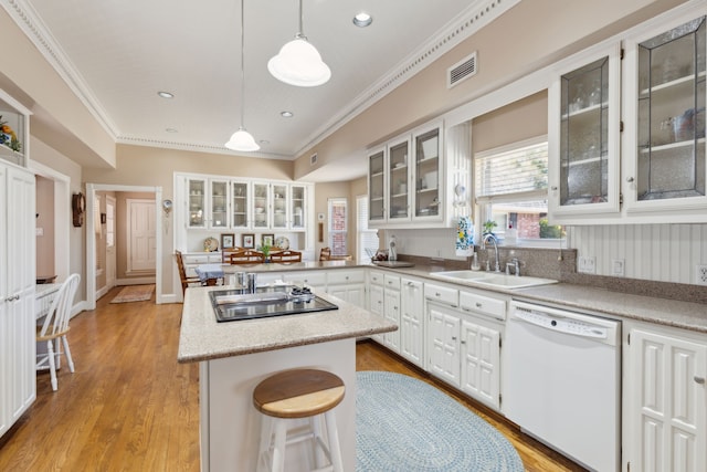 kitchen featuring black electric stovetop, white dishwasher, a sink, visible vents, and ornamental molding