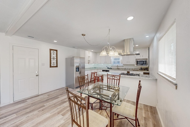 dining space with recessed lighting, light wood-type flooring, visible vents, and a chandelier