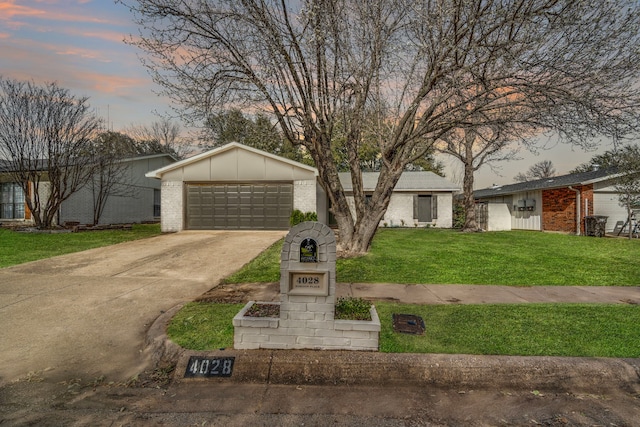 view of front facade featuring brick siding, a lawn, board and batten siding, and concrete driveway