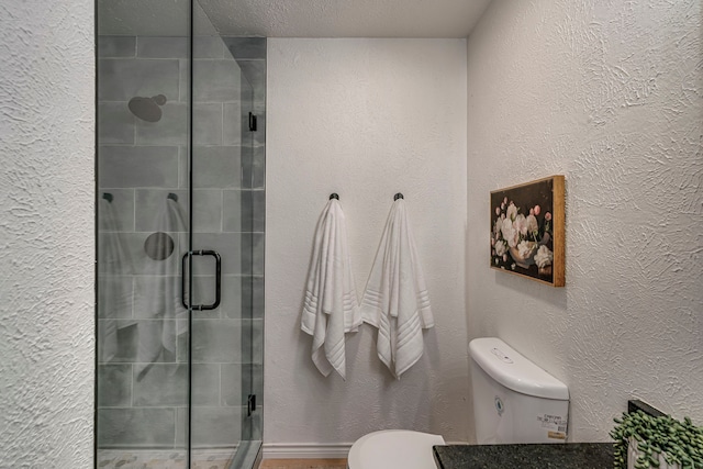 full bath featuring a shower stall, toilet, and a textured wall