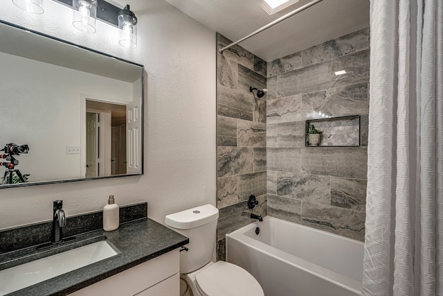 bathroom with a textured wall, toilet, vanity, and shower / bath combination with curtain