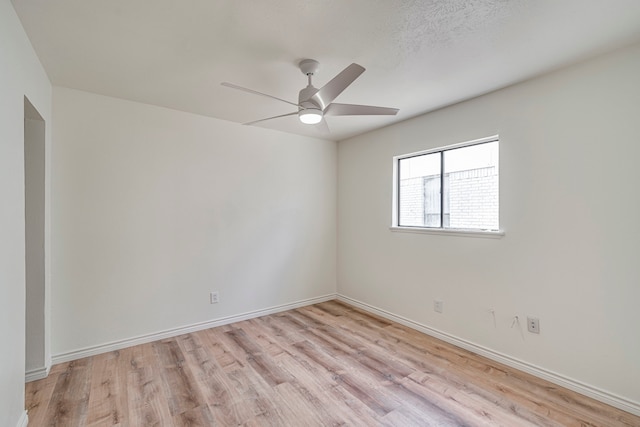 unfurnished room with a ceiling fan, baseboards, and light wood finished floors