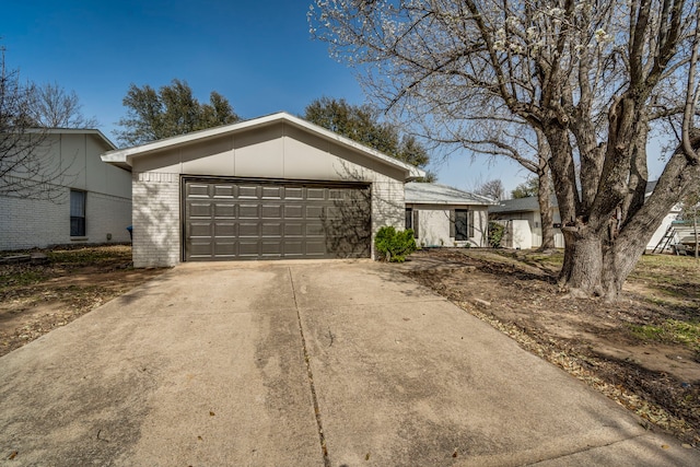 mid-century home featuring brick siding and a garage