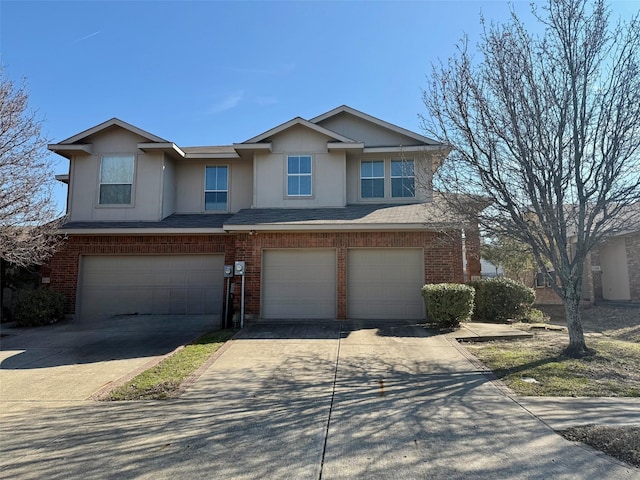 view of front of house featuring a garage, concrete driveway, brick siding, and a shingled roof