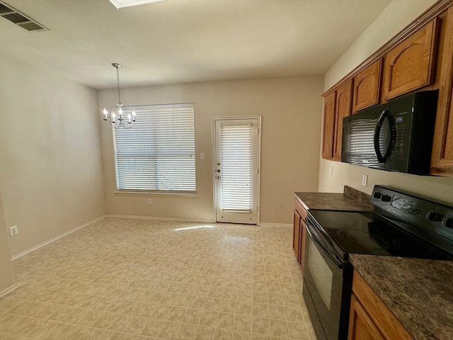 kitchen with brown cabinets, dark countertops, visible vents, and black appliances