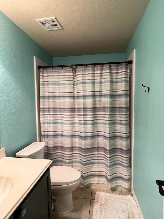 full bathroom with visible vents, toilet, tile patterned flooring, a textured ceiling, and vanity