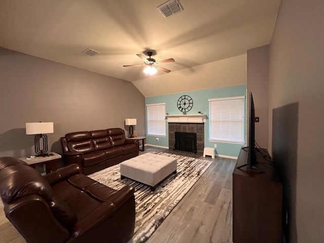 living area featuring baseboards, visible vents, ceiling fan, wood finished floors, and vaulted ceiling