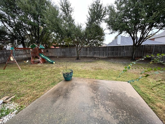 view of yard with a playground and a fenced backyard