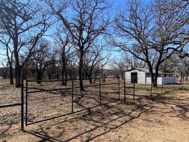 view of yard with a garage, fence, and an outdoor structure