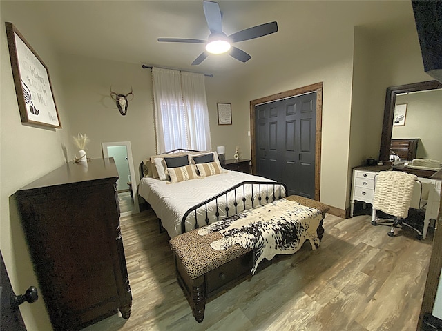 bedroom with a closet, wood finished floors, and a ceiling fan