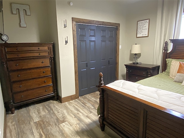 bedroom with light wood-style flooring and baseboards