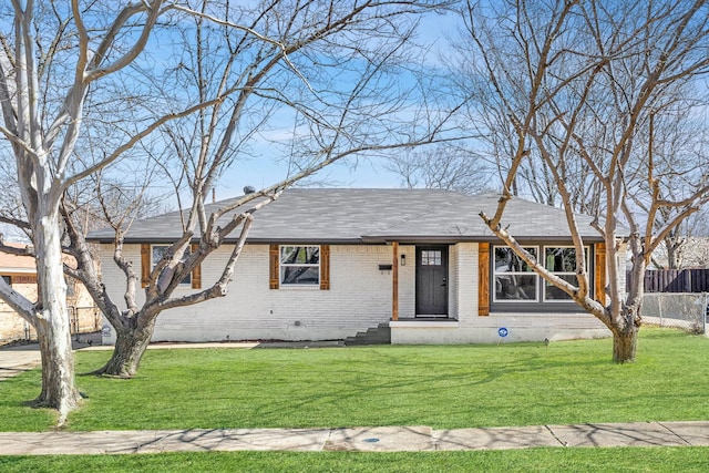 ranch-style home featuring crawl space, brick siding, fence, and a front lawn