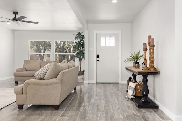 entrance foyer with baseboards, wood finished floors, and recessed lighting