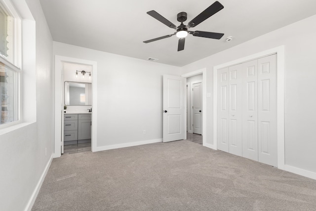 unfurnished bedroom with baseboards, carpet, visible vents, and a closet