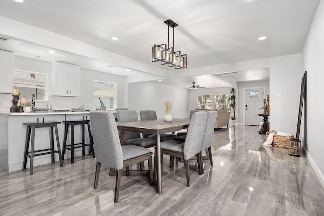 dining area with light wood finished floors, a ceiling fan, a wealth of natural light, and recessed lighting