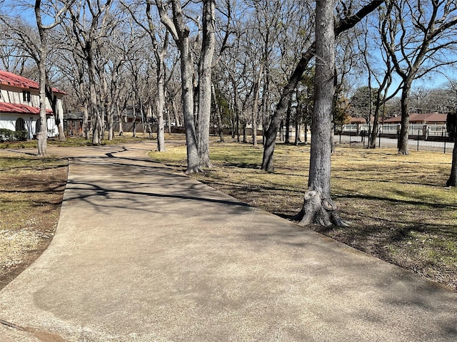 view of street featuring concrete driveway