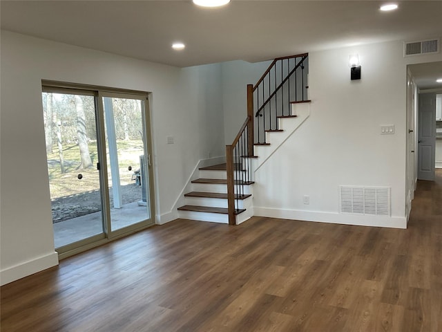 interior space featuring baseboards, visible vents, and wood finished floors