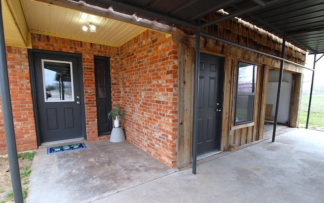 property entrance with brick siding