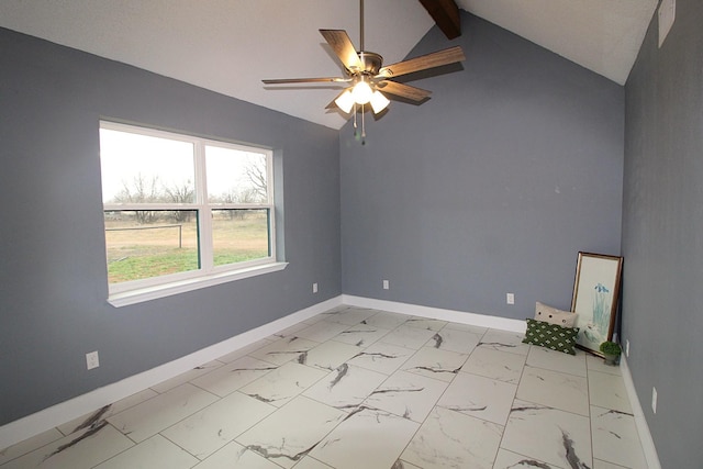 spare room with marble finish floor, baseboards, vaulted ceiling, and a ceiling fan