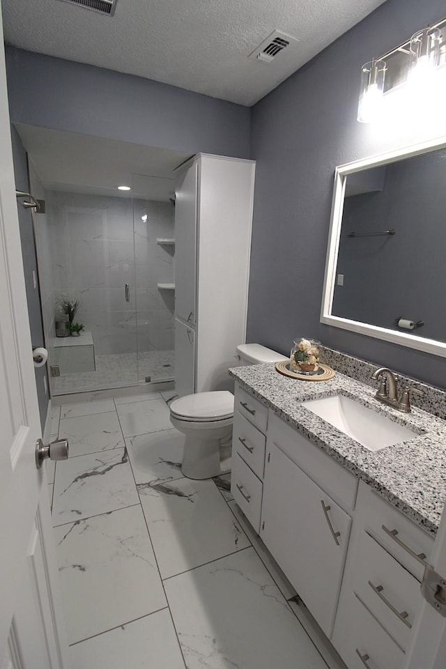 full bathroom with marble finish floor, visible vents, toilet, a shower stall, and a textured ceiling