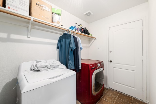 washroom with laundry area, visible vents, and washer and clothes dryer