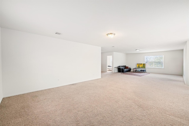 unfurnished living room featuring carpet flooring and visible vents