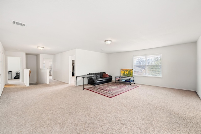 sitting room with visible vents and light carpet