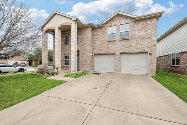 view of front of house featuring a garage, a front yard, concrete driveway, and brick siding