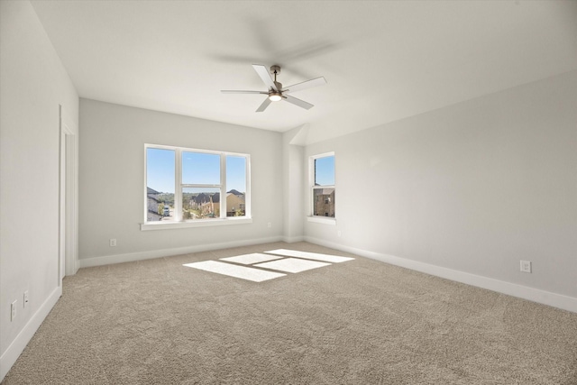 unfurnished room with carpet floors, ceiling fan, and baseboards