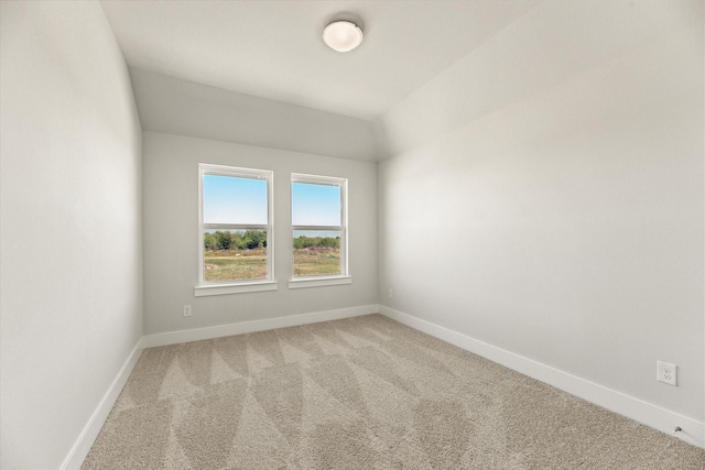 unfurnished room with light colored carpet and baseboards