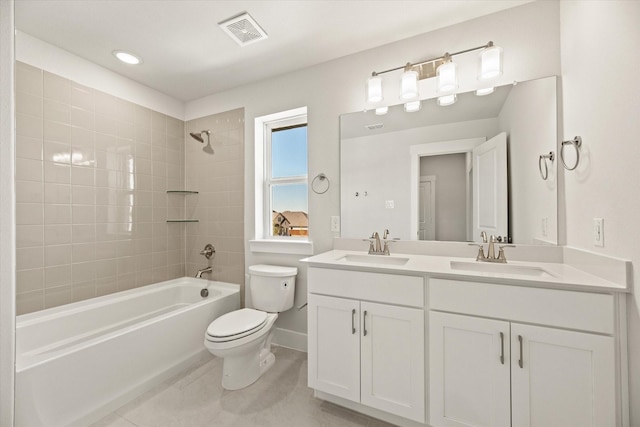 bathroom featuring bathtub / shower combination, visible vents, a sink, and toilet