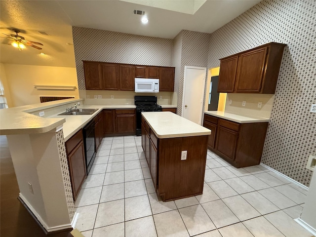 kitchen featuring light tile patterned floors, a sink, light countertops, black appliances, and wallpapered walls