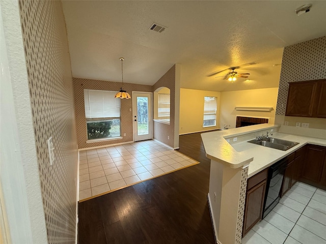 kitchen featuring black dishwasher, open floor plan, visible vents, and wallpapered walls