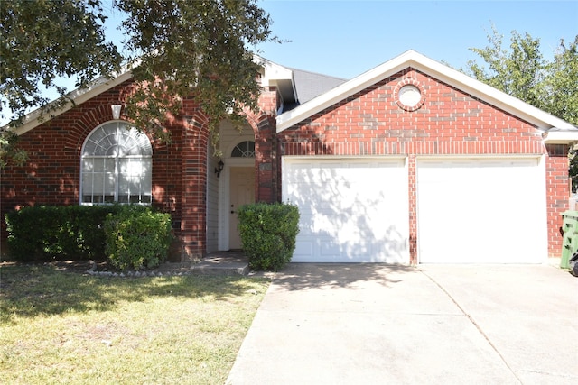 view of front of home with a garage, driveway, brick siding, and a front lawn