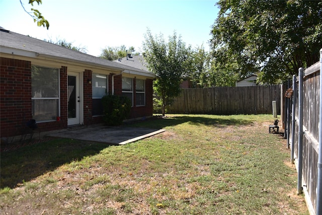 view of yard with a patio area and a fenced backyard