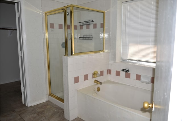 full bathroom with a garden tub, a shower stall, and tile patterned floors