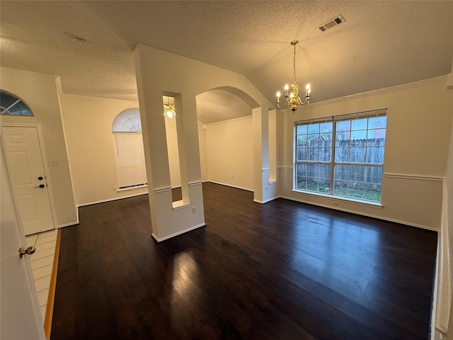 interior space with visible vents, an inviting chandelier, vaulted ceiling, a textured ceiling, and wood finished floors