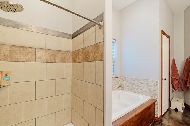 full bath featuring a garden tub and a tile shower