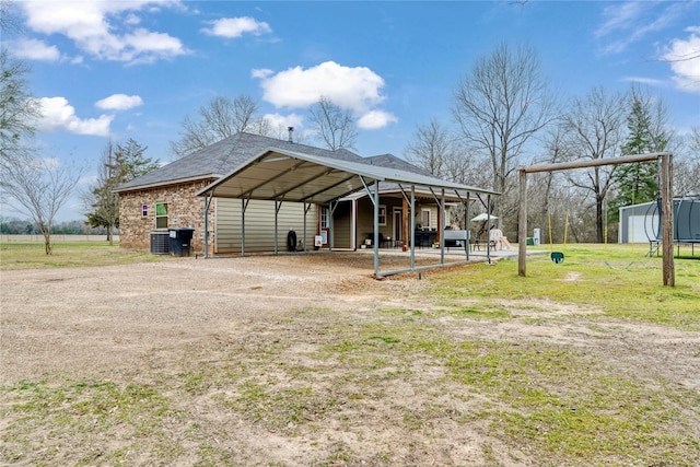 view of outbuilding with an outbuilding, central AC, and driveway