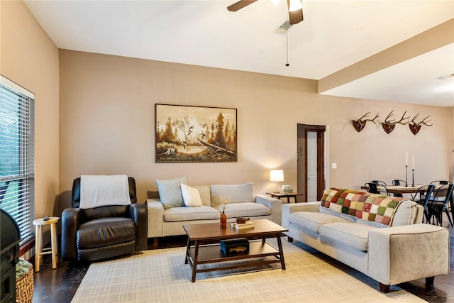 living room featuring a ceiling fan and visible vents