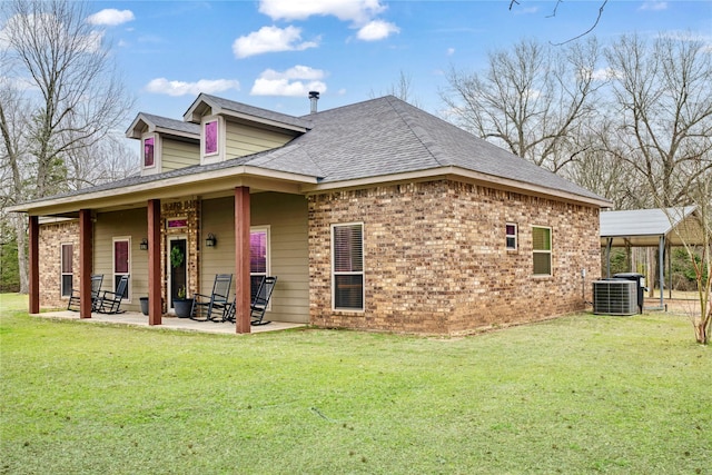 exterior space with central AC, a yard, brick siding, and a patio