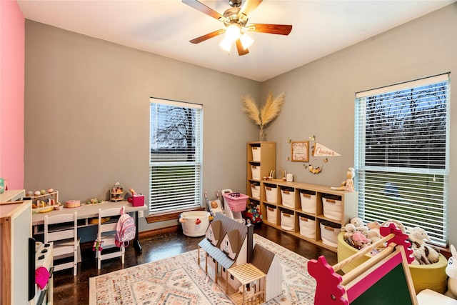 playroom with baseboards and a ceiling fan