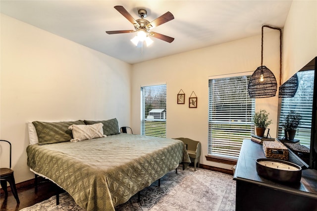 bedroom featuring ceiling fan and baseboards