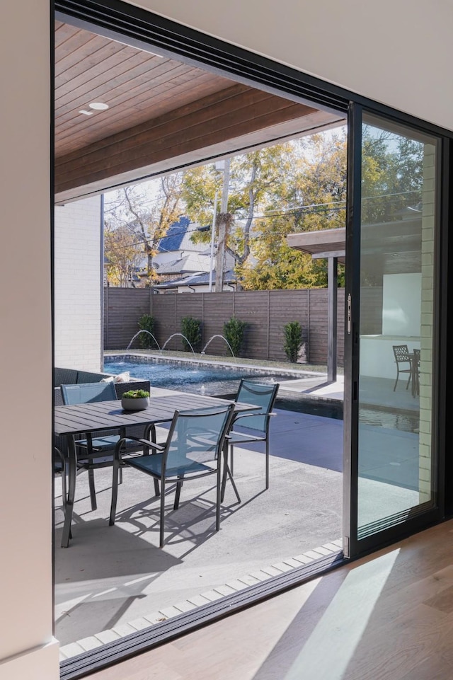 view of patio with outdoor dining space and fence