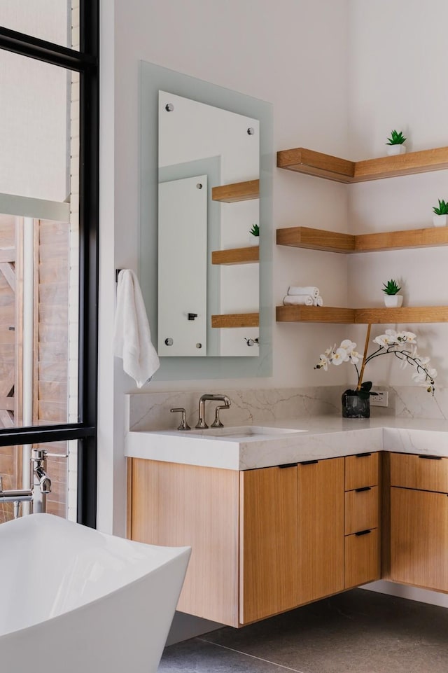 full bath featuring a freestanding bath and vanity