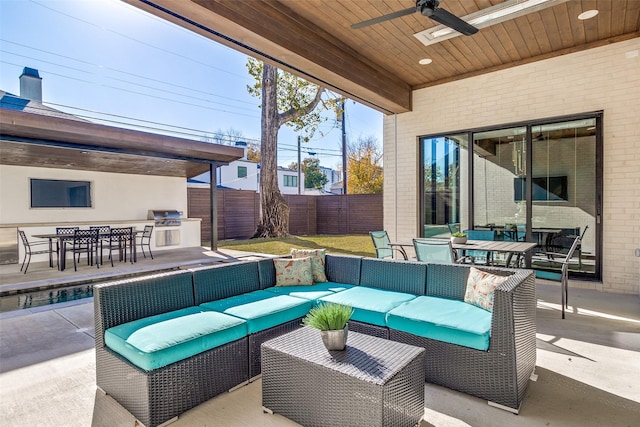 view of patio / terrace with outdoor dining area, an outdoor hangout area, area for grilling, and fence