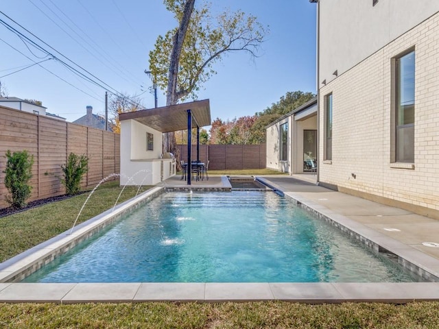 view of pool with a fenced in pool, a lawn, a fenced backyard, and a patio area